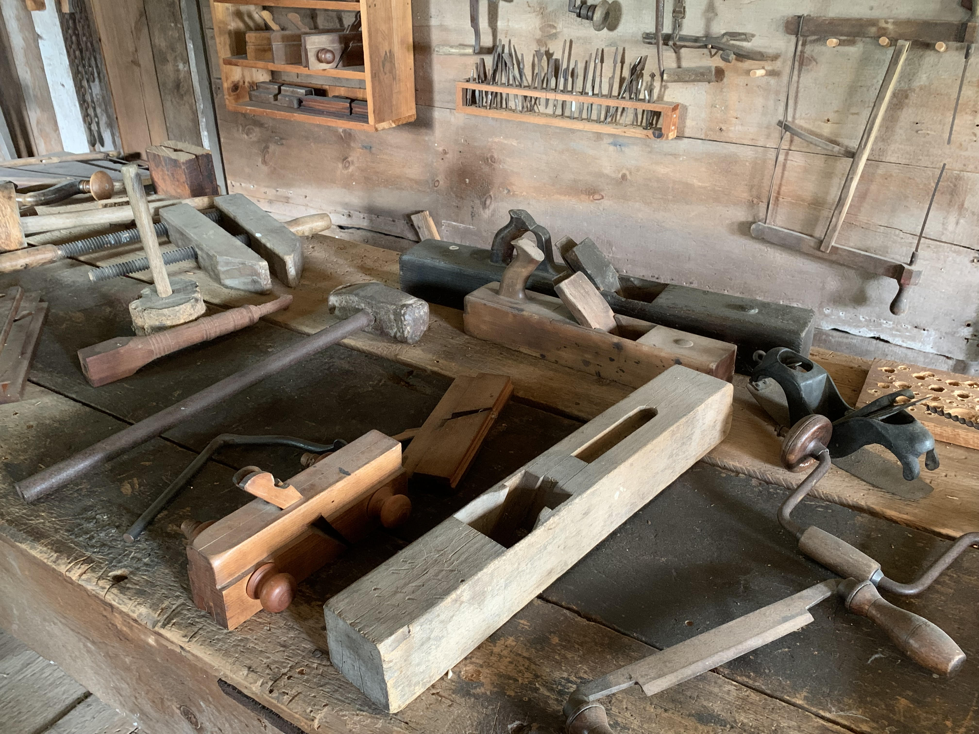 pieces of wood and tools laying on a bench