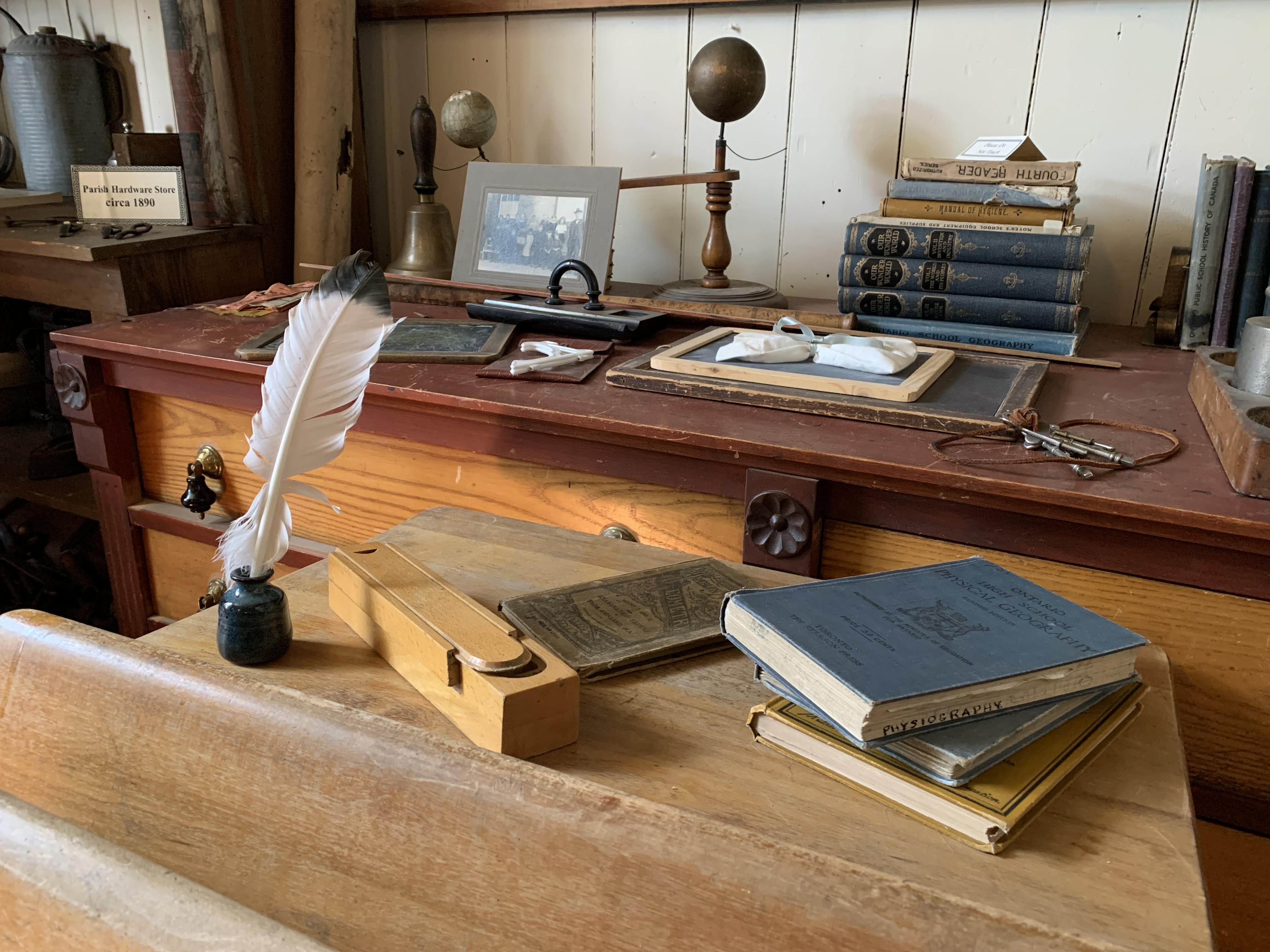 Desk with books and feather on it